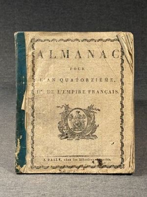 an old book sitting on top of a table on a gray surface