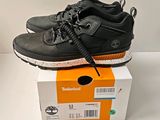a pair of black shoes sitting on top of a box