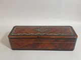 a small wooden box with a decorative design on the lid