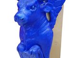 a blue sculpture of a bull with wings on it ' s head