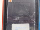 a broken cell phone in a box with a broken screen