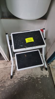 two air conditioners sitting on top of a shelf next to a toilet