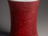 a close up of a red and white cup on a table