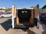 a white van with its doors open in a parking lot