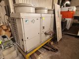 a large air conditioner in a building with a lot of boxes
