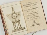 an open book with a drawing of a clock on it