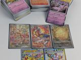 a lot of different pokemon cards on the table