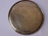a silver plate on a white table with a white table cloth
