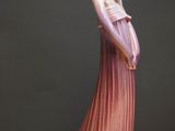 a figurine of a woman standing on a table