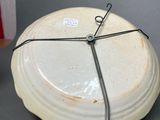 a white plate with a black wire around it on a table