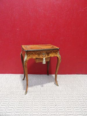 dollhouse miniature table with a red wall and white tile floor