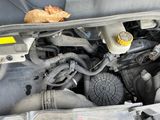 a close up of a car ' s engine with the hood open