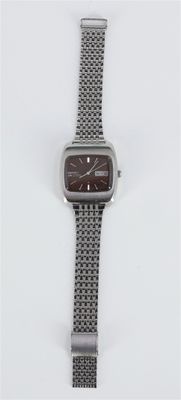 a close up of a watch on a white surface with a white background
