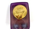 a purple and gold ring with a gold cross on it