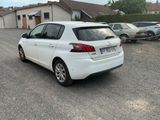 a white car parked in a parking lot next to a house
