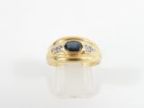 a yellow gold ring with a blue sapphire and diamonds