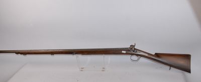 an old rifle on display in a glass case