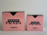 a pair of pink prada boxes sitting on top of a white table