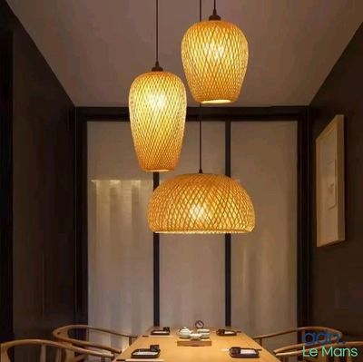 three lamps hanging over a table in a room