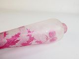 a glass bottle with pink and white designs on it