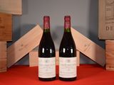 two bottles of wine sitting next to each other on a table