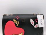 a black purse with a red heart on it