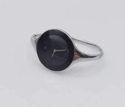 an image of a silver ring with a black face on a white surface