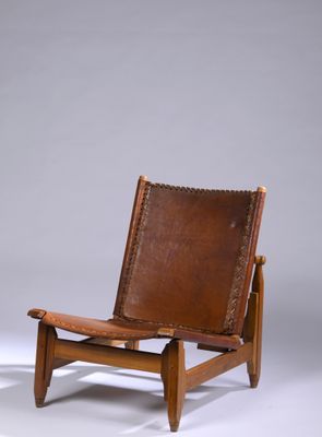 a pair of brown leather lounge chairs on a white background
