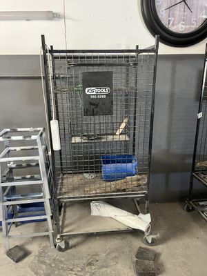 an image of a large metal cage with a clock in the background
