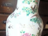 a vase that is sitting on a table with a hat on it