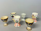 five different types of cups and bowls on the table