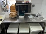 a picture of a kitchen with a lot of food on the counter