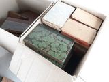a box full of old books sitting on the floor