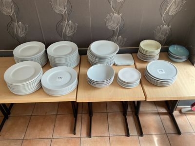 a lot of plates and bowls on the table