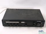 a close up of a black radio receiver on a white surface