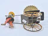 toy figurine of a man pulling a horse drawn carriage