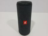 a close up of a black speaker on a white surface