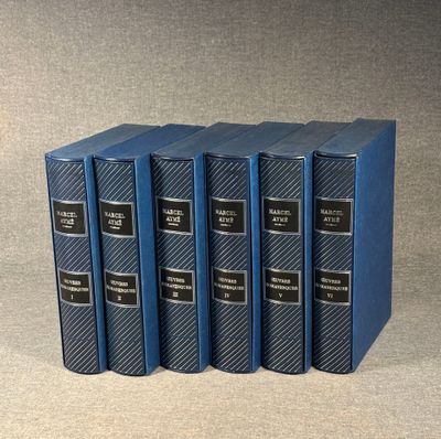 four blue books sitting on top of each other on a table
