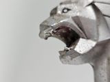 a close up of a statue of a lion with its mouth open