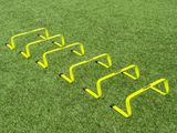 a group of yellow ladders sitting on top of a lush green field