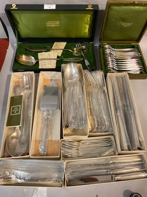 many silverware items in a box on a table