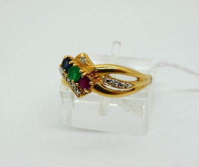 a close up of a gold ring with a green, red and white stone