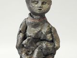 an image of a small statue of a child holding a teddy bear