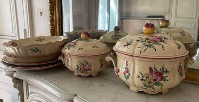 many dishes on a table with a mirror in the background