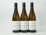 three bottles of wine sitting on top of a table next to each other