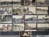 many pictures of old buildings displayed on the wall