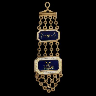 un gros plan d'un collier doré et bleu sur fond noir