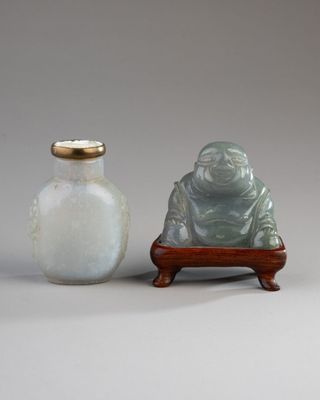 two small vases sitting next to each other on a table