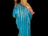 the statue of jesus is holding a cross and wearing a blue robe