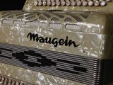 a close up of an old accordion with the words mougen on it